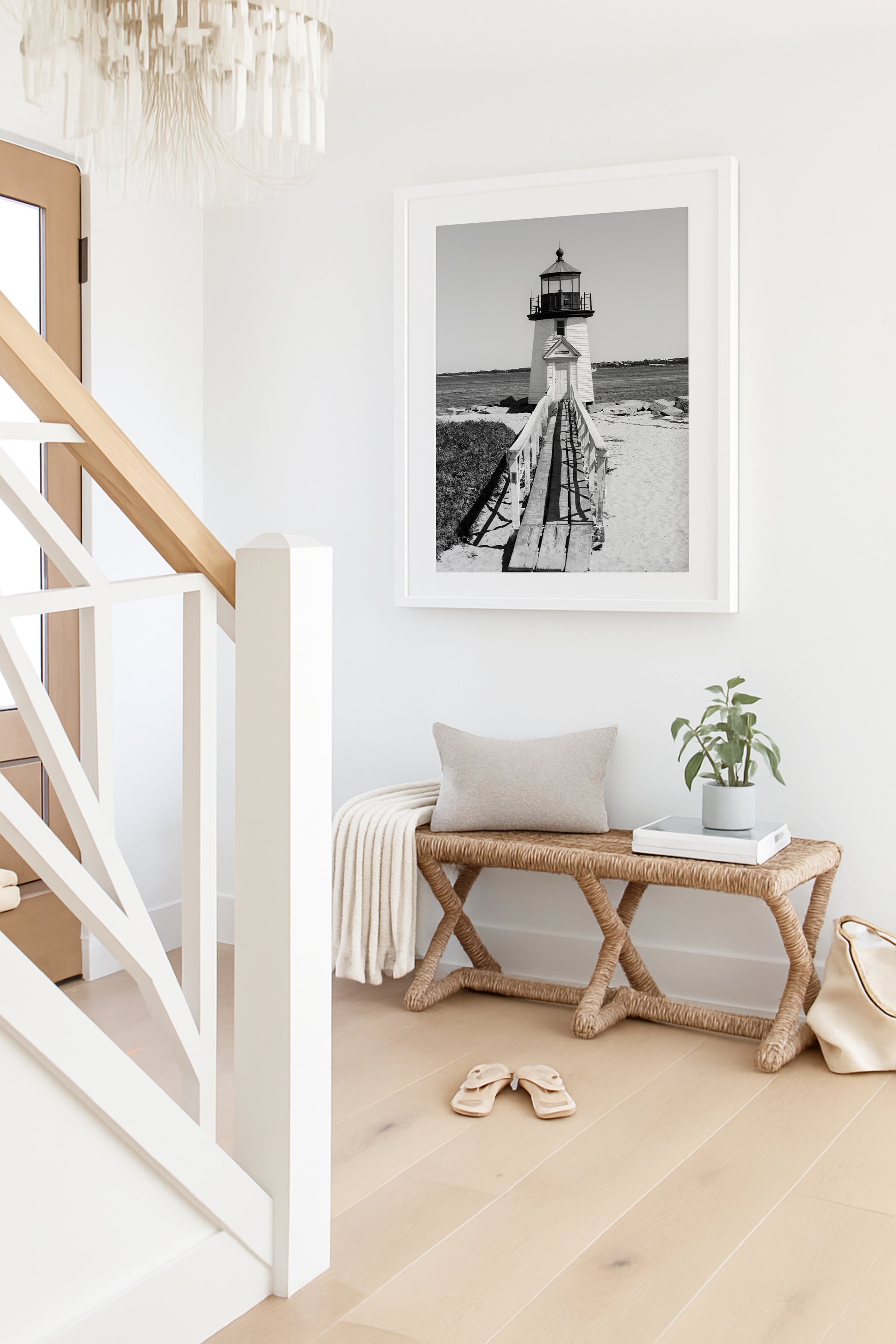 Black and white fine art photograph of Brant Point Lighthouse on Nantucket Island — wooden boardwalk leading to the white lighthouse tower with Nantucket Harbor in the background