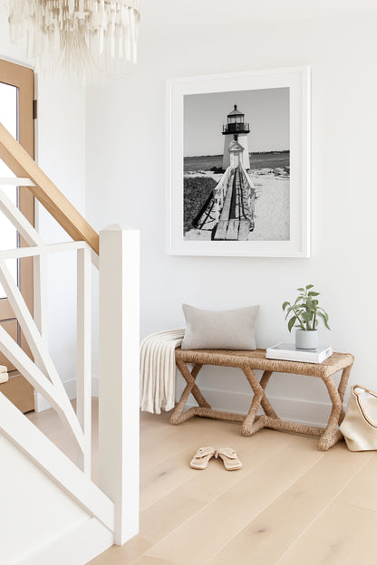 Black and white fine art photograph of Brant Point Lighthouse on Nantucket Island — wooden boardwalk leading to the white lighthouse tower with Nantucket Harbor in the background