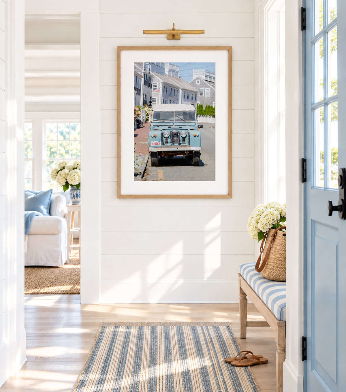 Color fine art photograph of a vintage powder blue Land Rover Series parked on a cobblestone street in Nantucket — Massachusetts vanity plate BLUSKY, grey shingle cottages and hydrangeas in the background