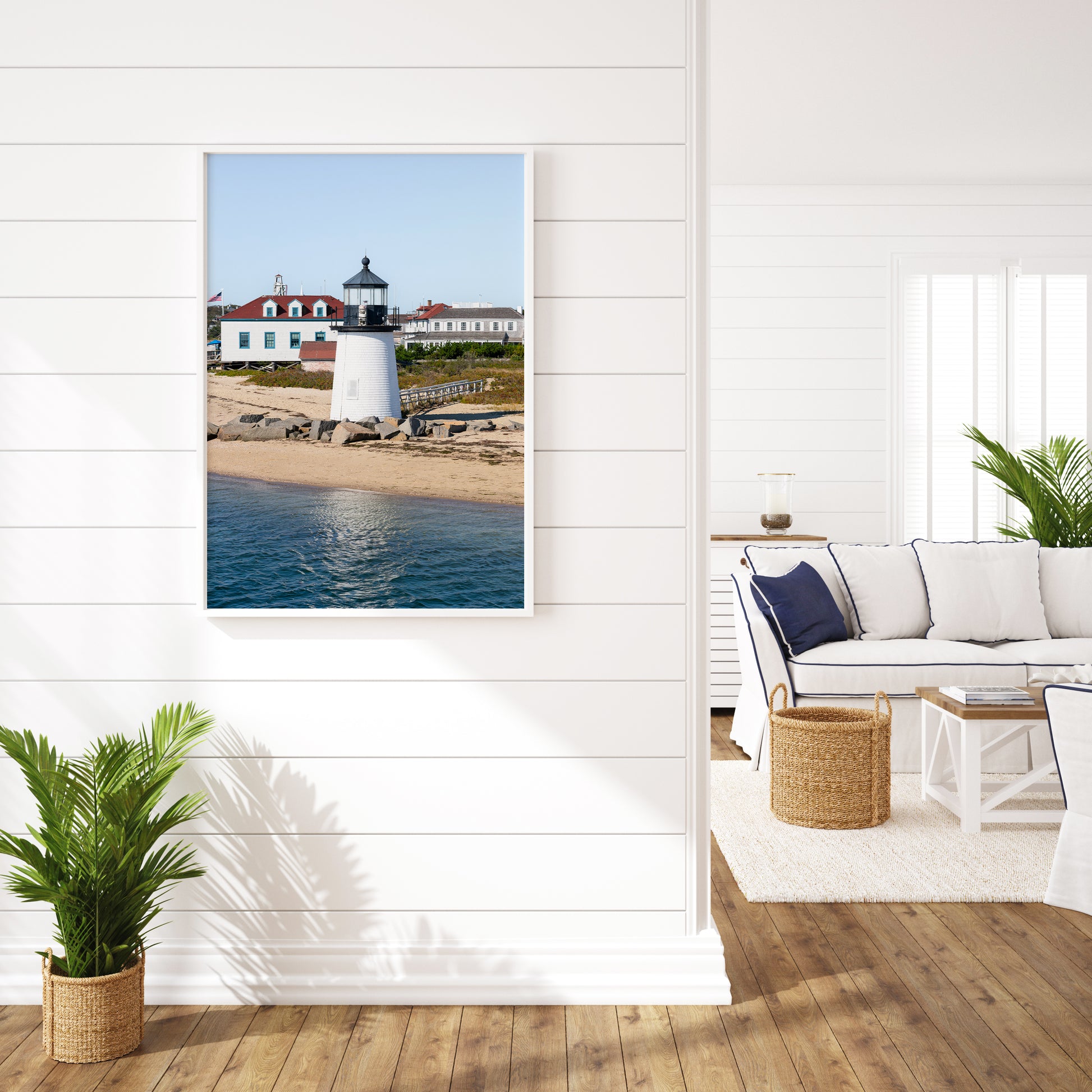 Brant Point Lighthouse print in Nantucket, featuring a white tower, rocky shoreline, and blue sky—ideal for nautical and coastal wall decor.