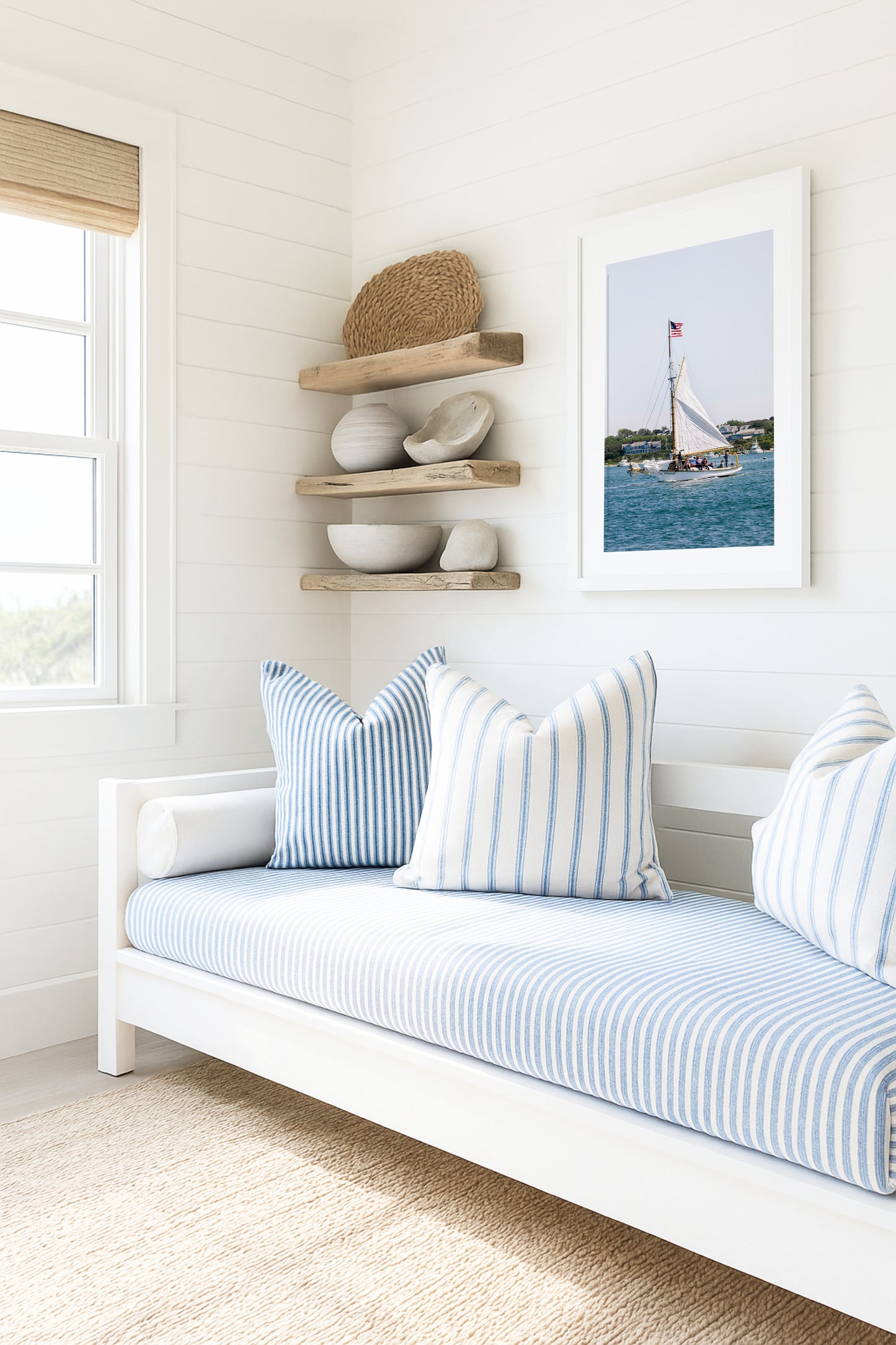 Sailboat cruising in Nantucket Harbor with white sails raised and an American flag flying, photographed on a clear summer day along the New England coastline.