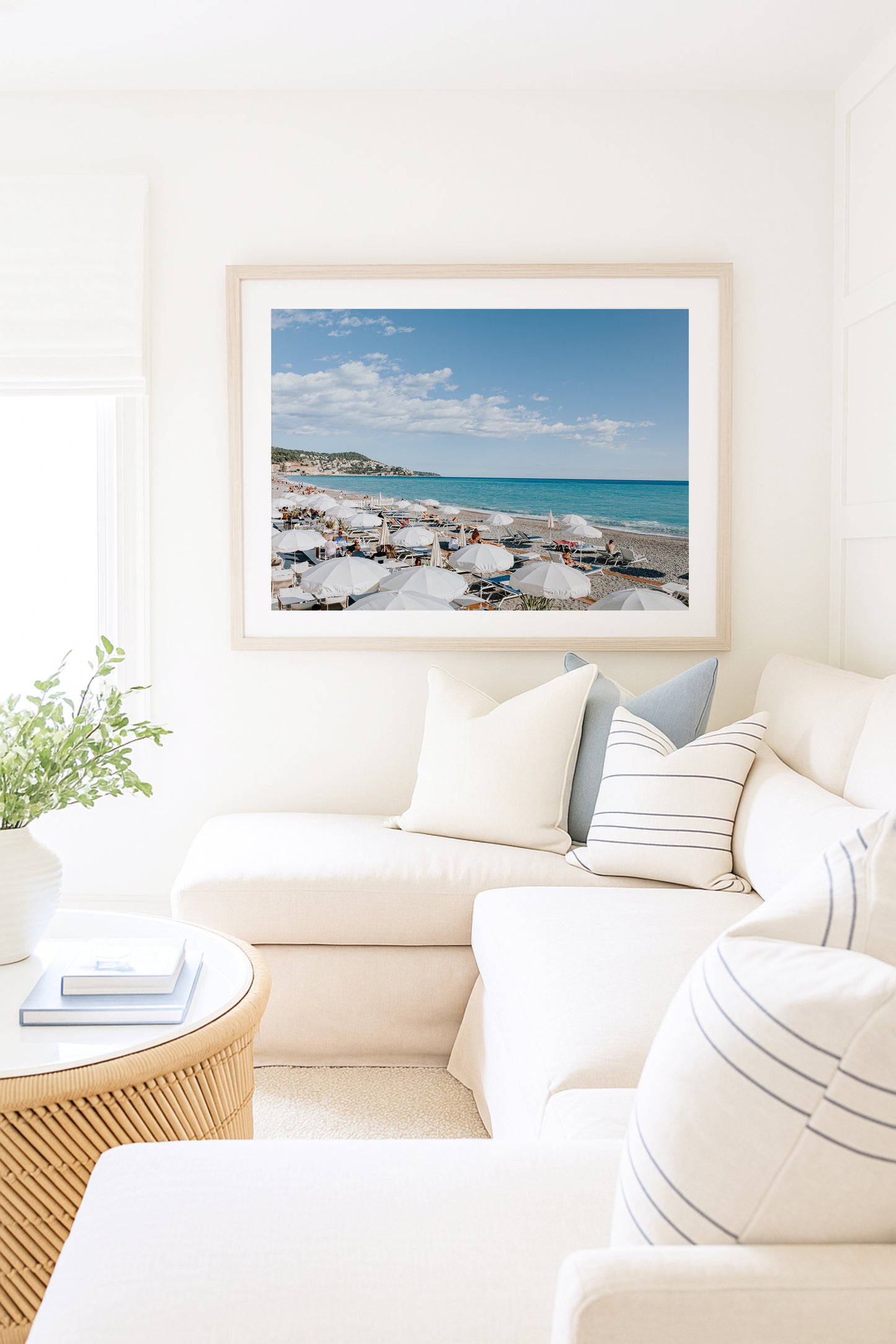 Nice, France beach umbrella print featuring white umbrellas along the coast. Coastal French Riviera wall art in horizontal format, ideal for bright and modern interiors.