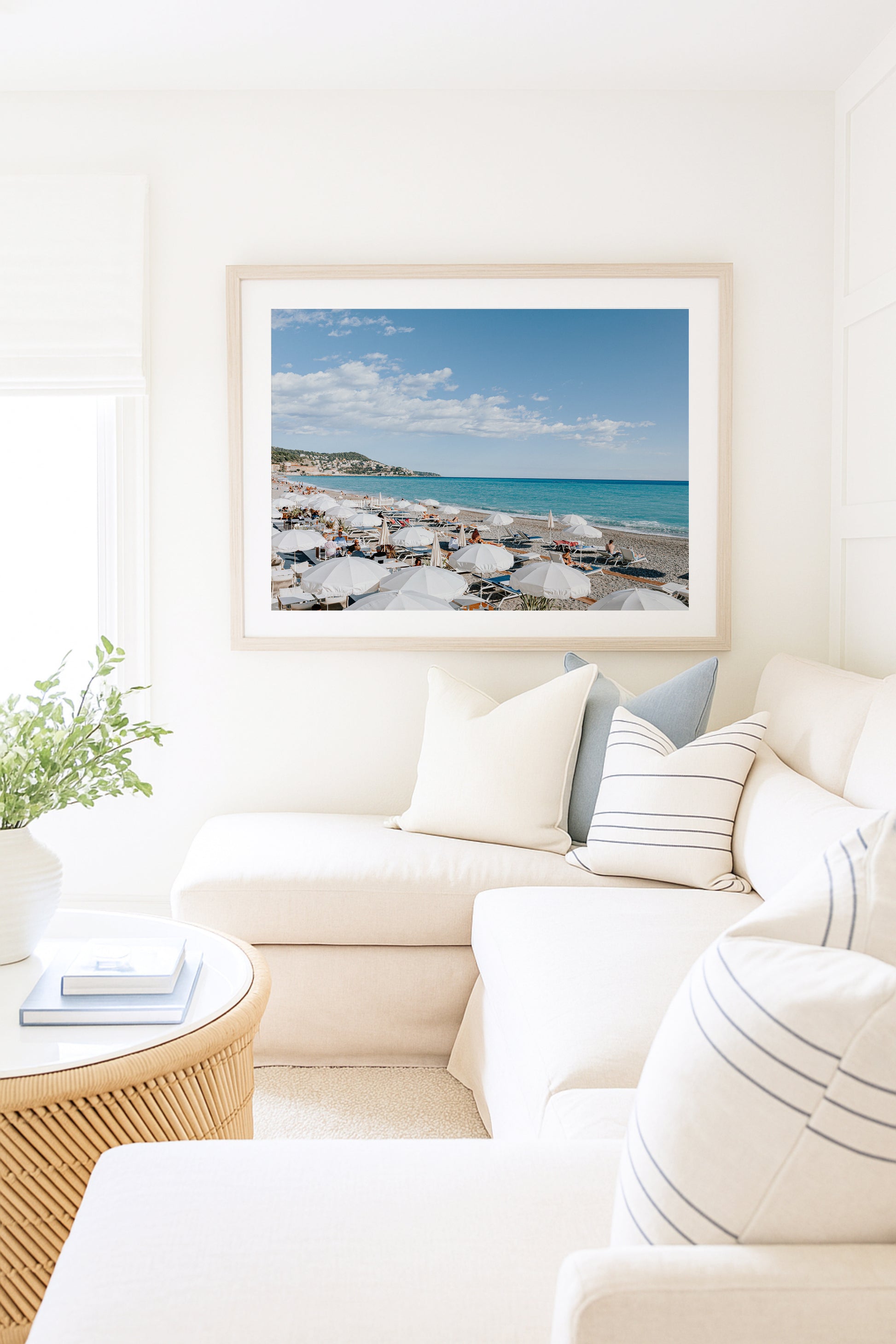 Nice, France beach umbrella print featuring white umbrellas along the coast. Coastal French Riviera wall art in horizontal format, ideal for bright and modern interiors.