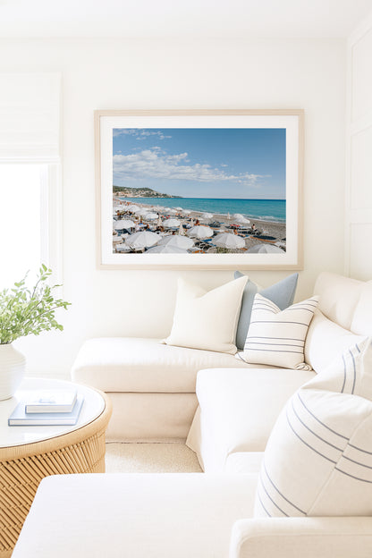 Nice, France beach umbrella print featuring white umbrellas along the coast. Coastal French Riviera wall art in horizontal format, ideal for bright and modern interiors.