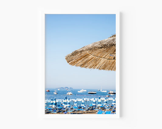 Positano beach photography print with straw umbrella and Amalfi Coast sea view – modern coastal wall art for beach house or Airbnb decor