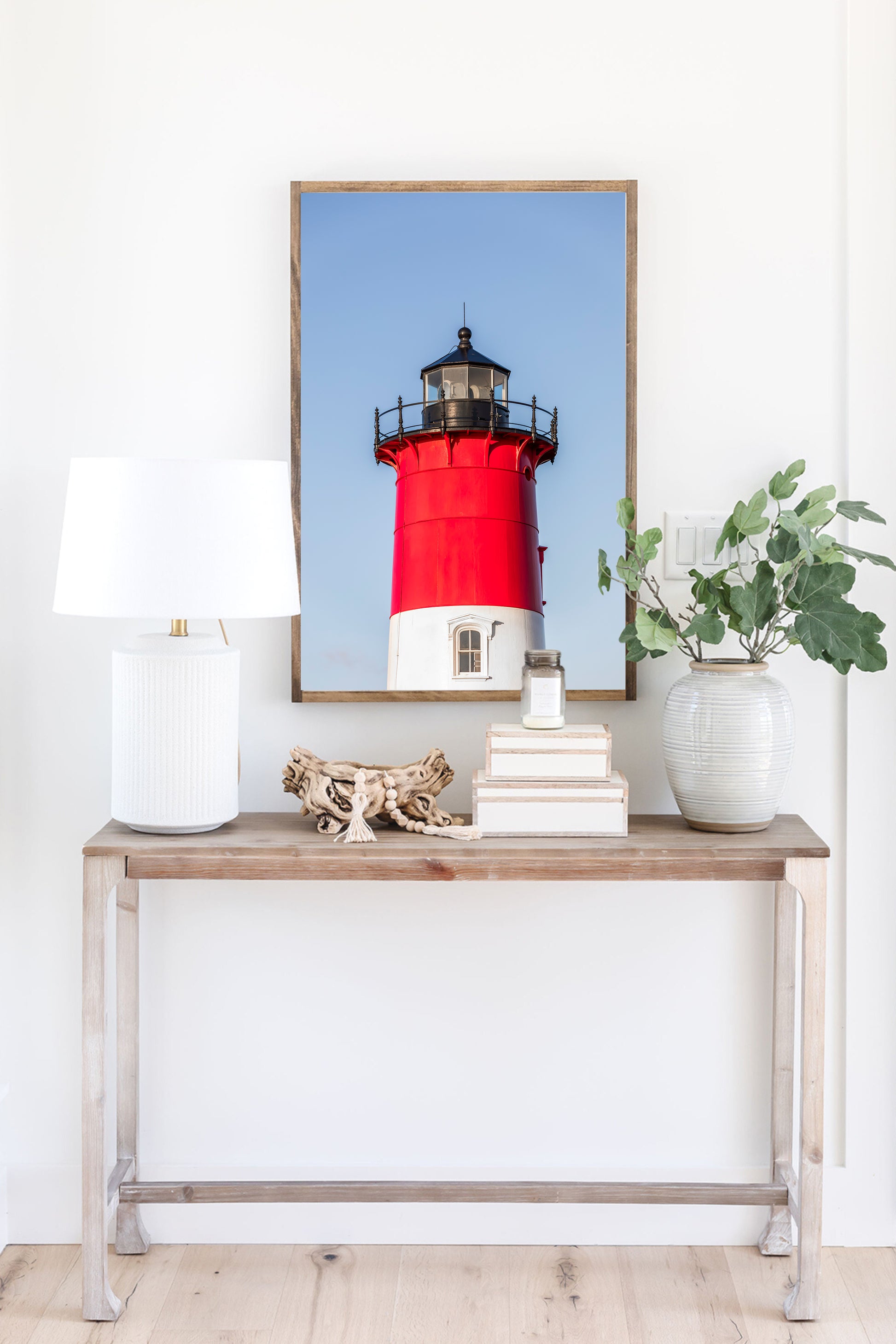 Vertical photograph of the red and white Nauset Lighthouse in Eastham, Massachusetts, set against a clear blue sky with no dunes or beach in view
