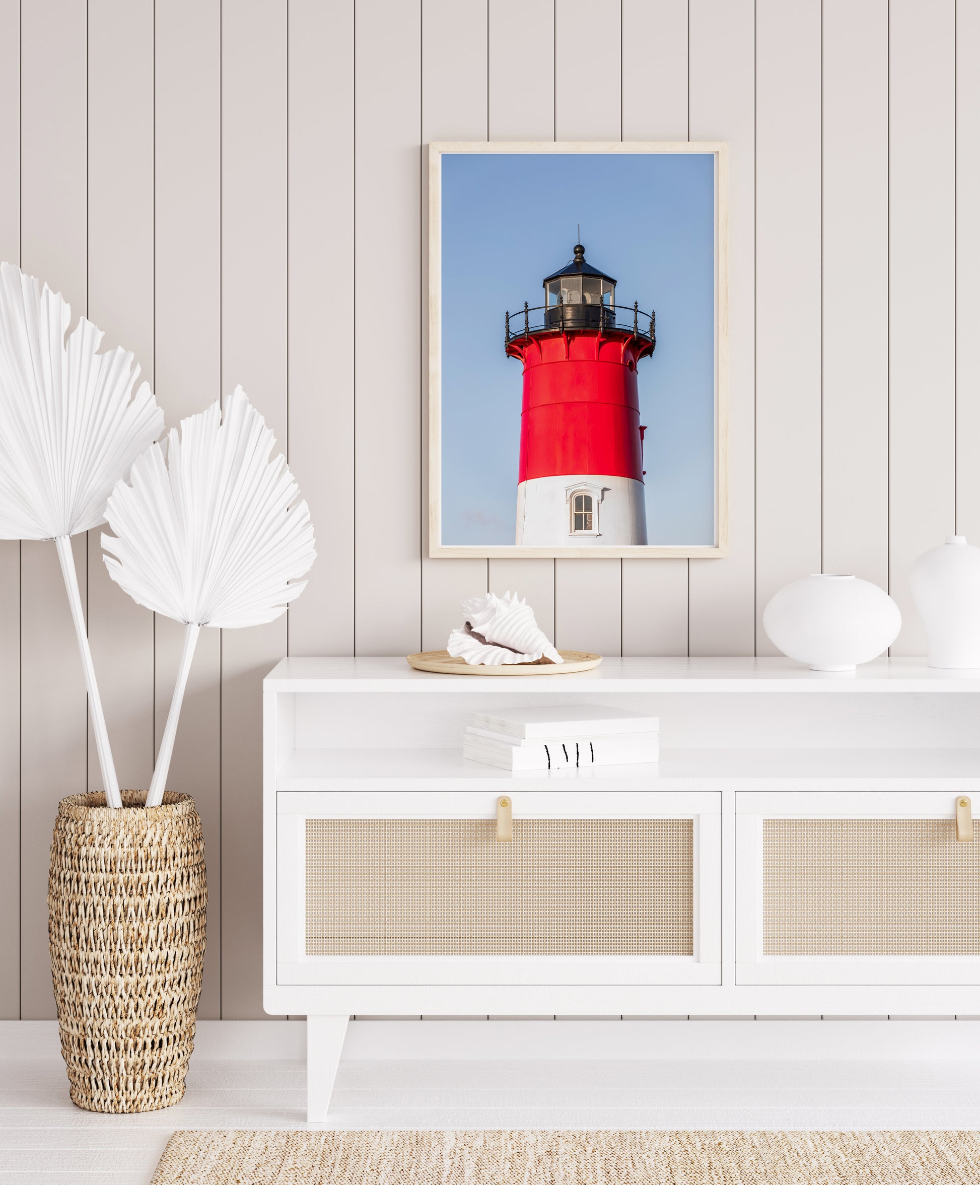 Vertical photograph of the red and white Nauset Lighthouse in Eastham, Massachusetts, set against a clear blue sky with no dunes or beach in view
