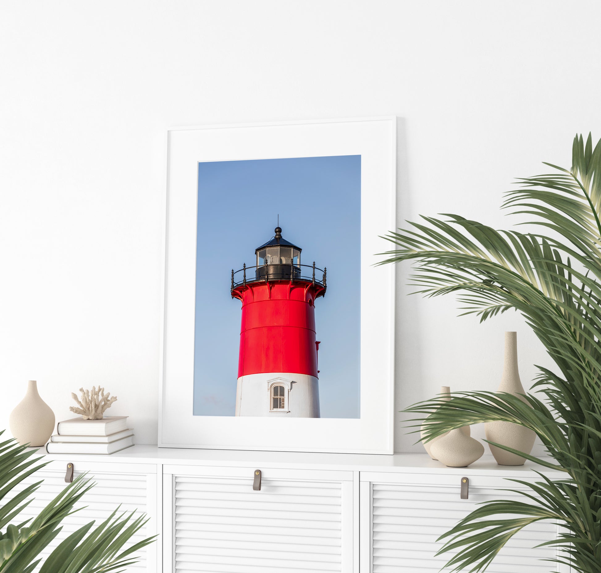 Vertical photograph of the red and white Nauset Lighthouse in Eastham, Massachusetts, set against a clear blue sky with no dunes or beach in view