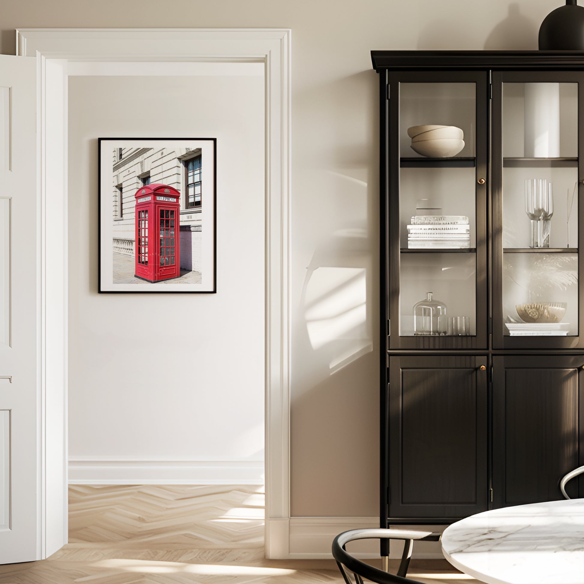 A classic red telephone booth stands out in vivid color against a black and white London street scene. A bold and graphic British landmark print for home or office decor.