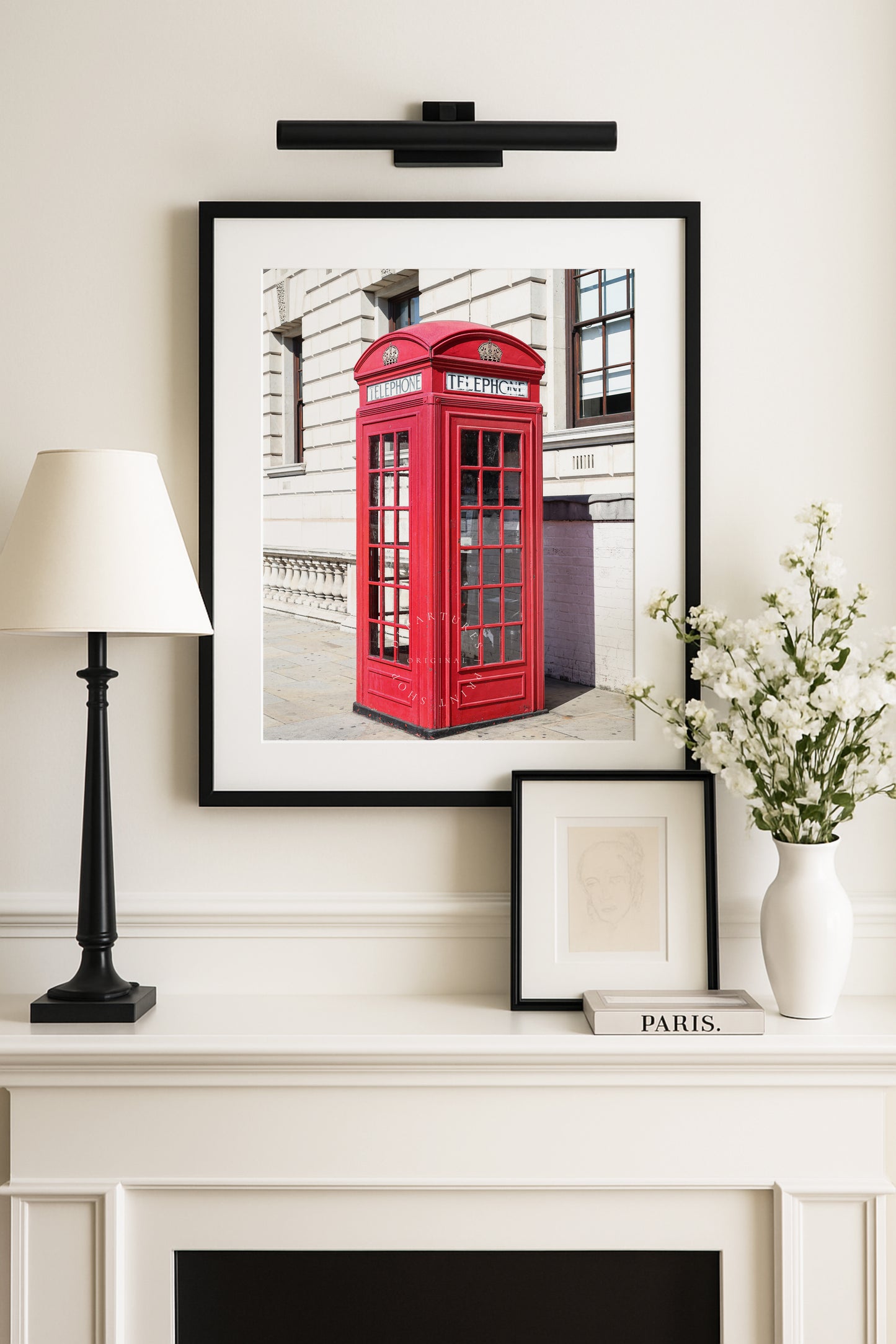 A classic red telephone booth stands out in vivid color against a black and white London street scene. A bold and graphic British landmark print for home or office decor.