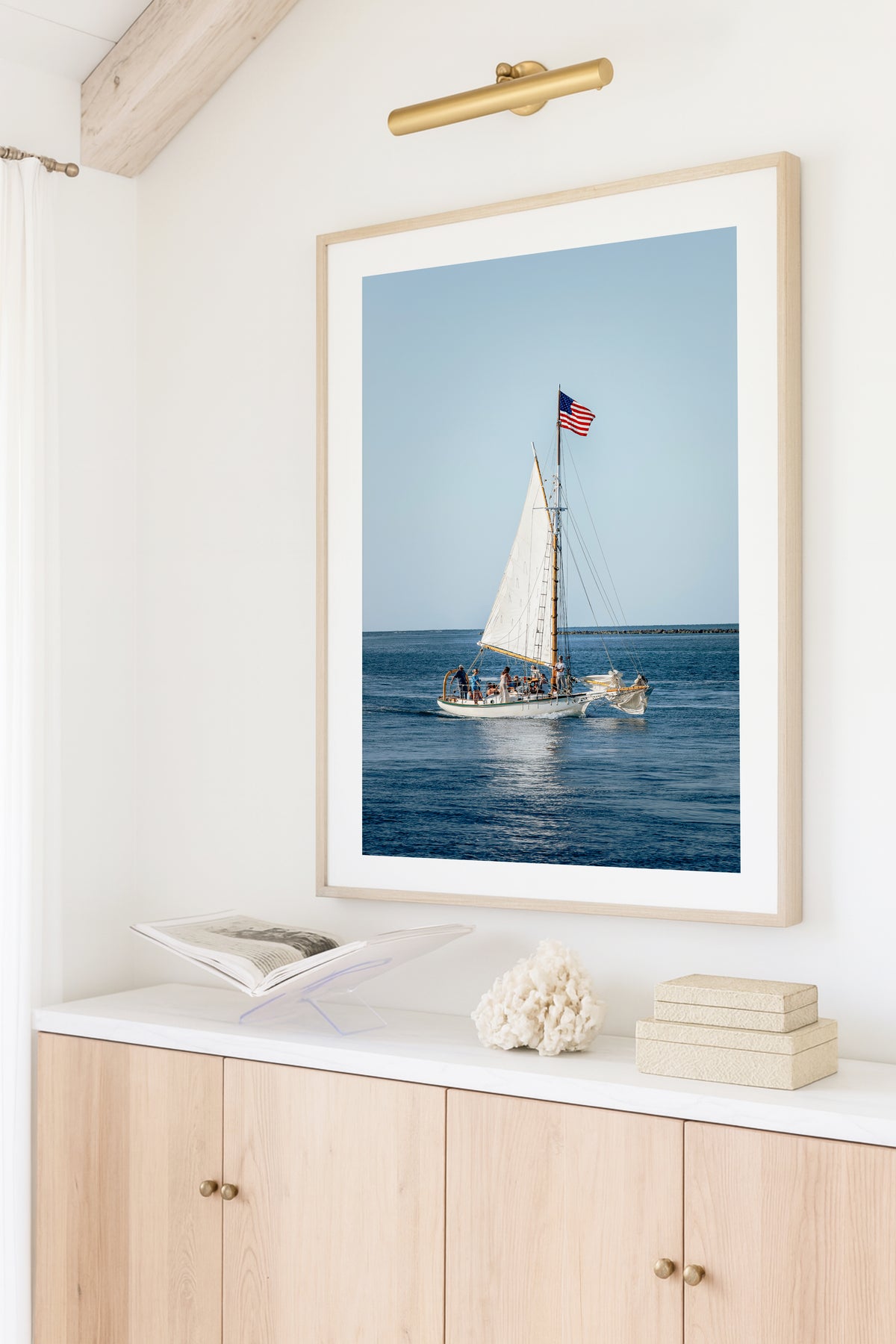 Nantucket Harbor sailboat photography print, classic wooden sailing vessel with American flag on deep blue water, coastal nautical wall art for beach house, living room, or home office