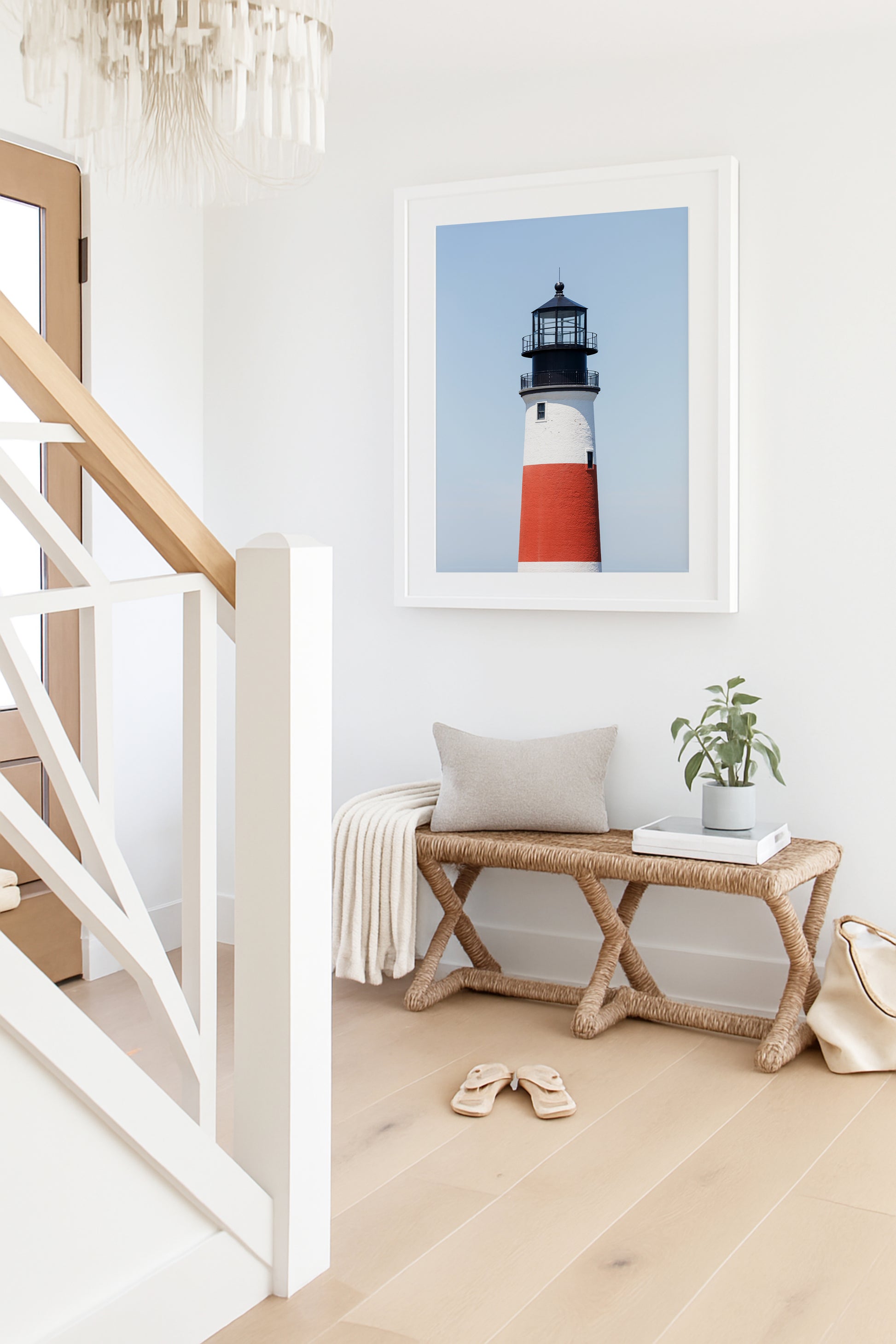Color fine art photograph of Sankaty Head Lighthouse on Nantucket Island — red and white banded tower against a soft blue sky.