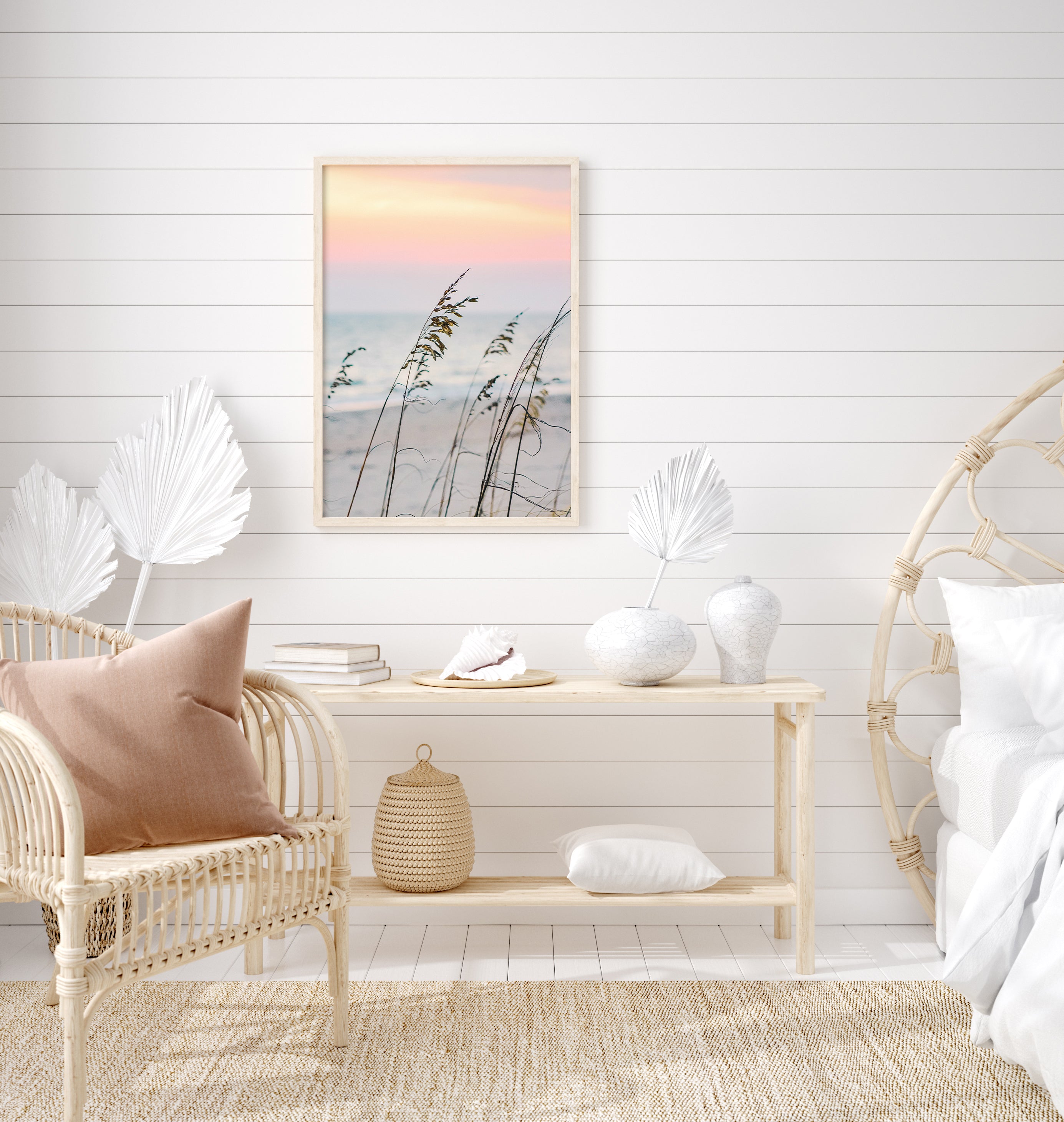 Sea oats on a sandy beach at sunset with soft pastel sky and ocean in the background