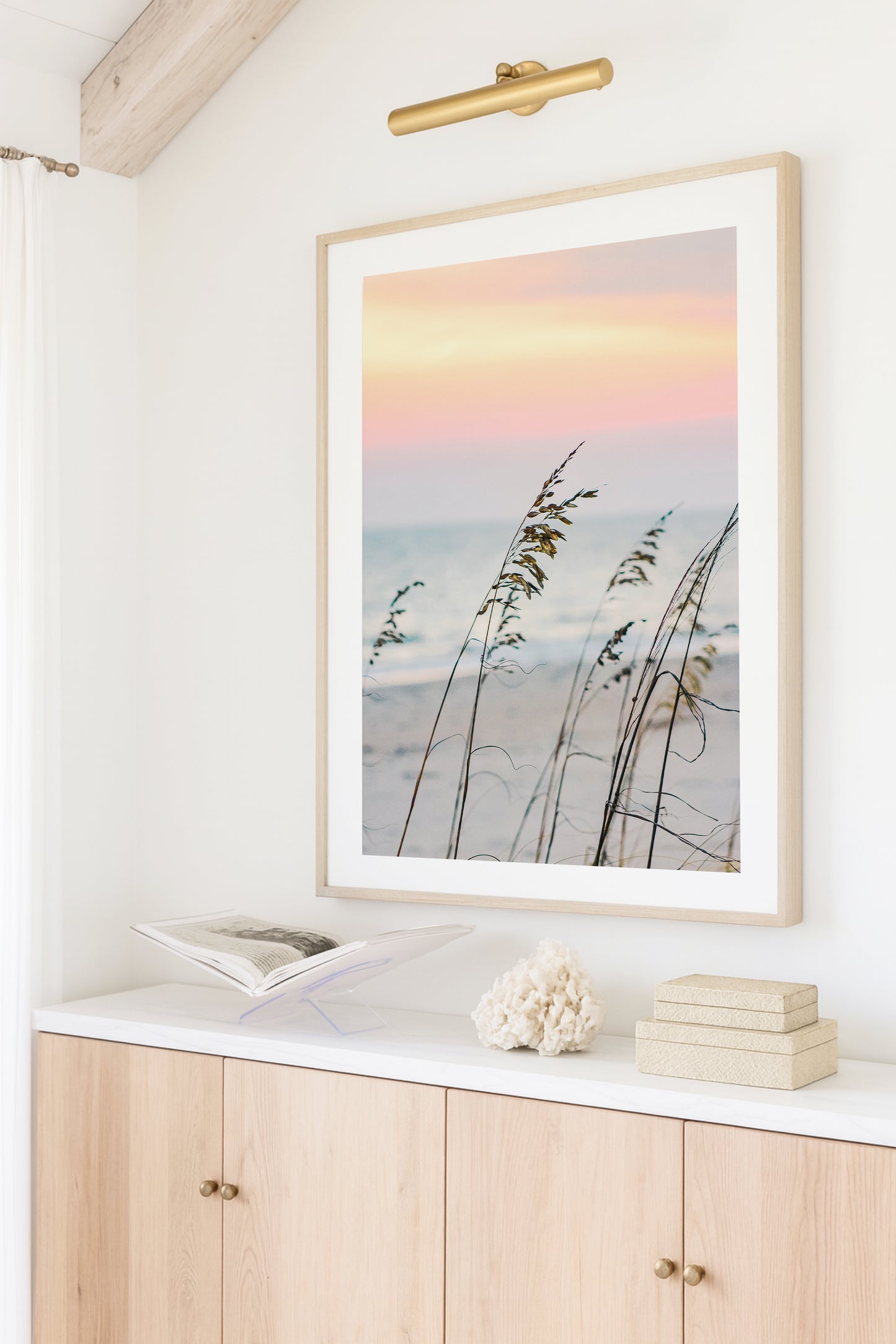 Color fine art photograph of sea oats swaying in the foreground against a soft pink and peach sunset over the Carolina coast — dreamy coastal beach wall art