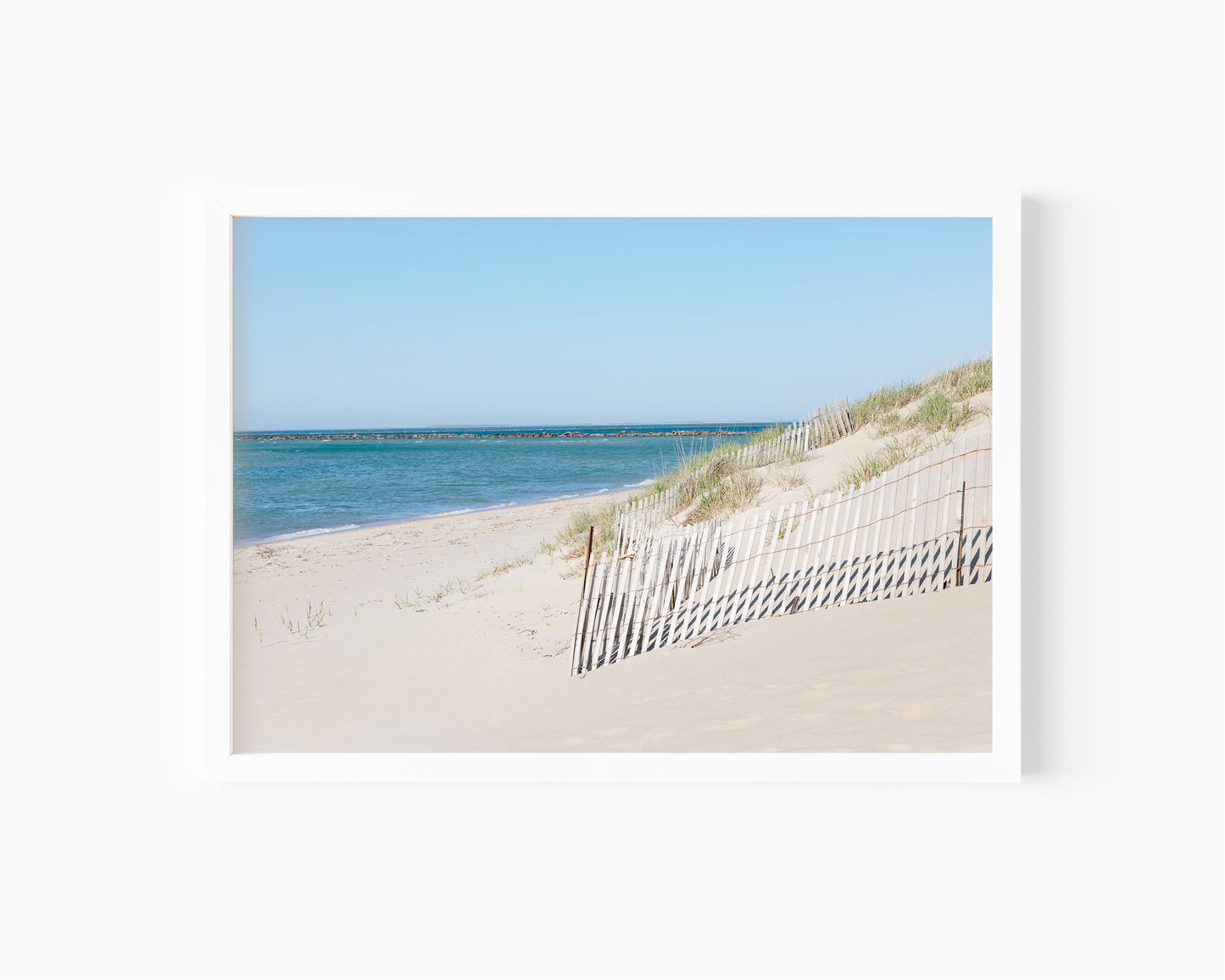 Horizontal beach photography print of Steps Beach on Nantucket Island with sand dunes, beach fencing, and blue ocean water.