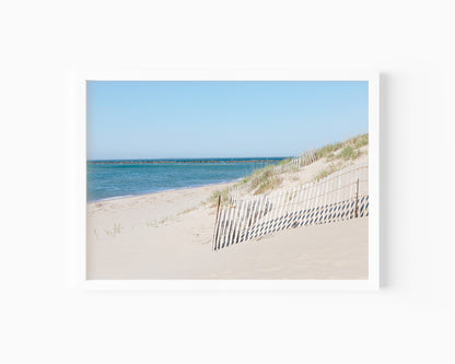 Horizontal beach photography print of Steps Beach on Nantucket Island with sand dunes, beach fencing, and blue ocean water.