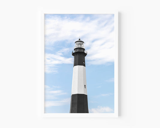 Fine art photograph of Tybee Island Lighthouse near Savannah, Georgia black and white striped tower against a soft blue sky, shot from below looking up