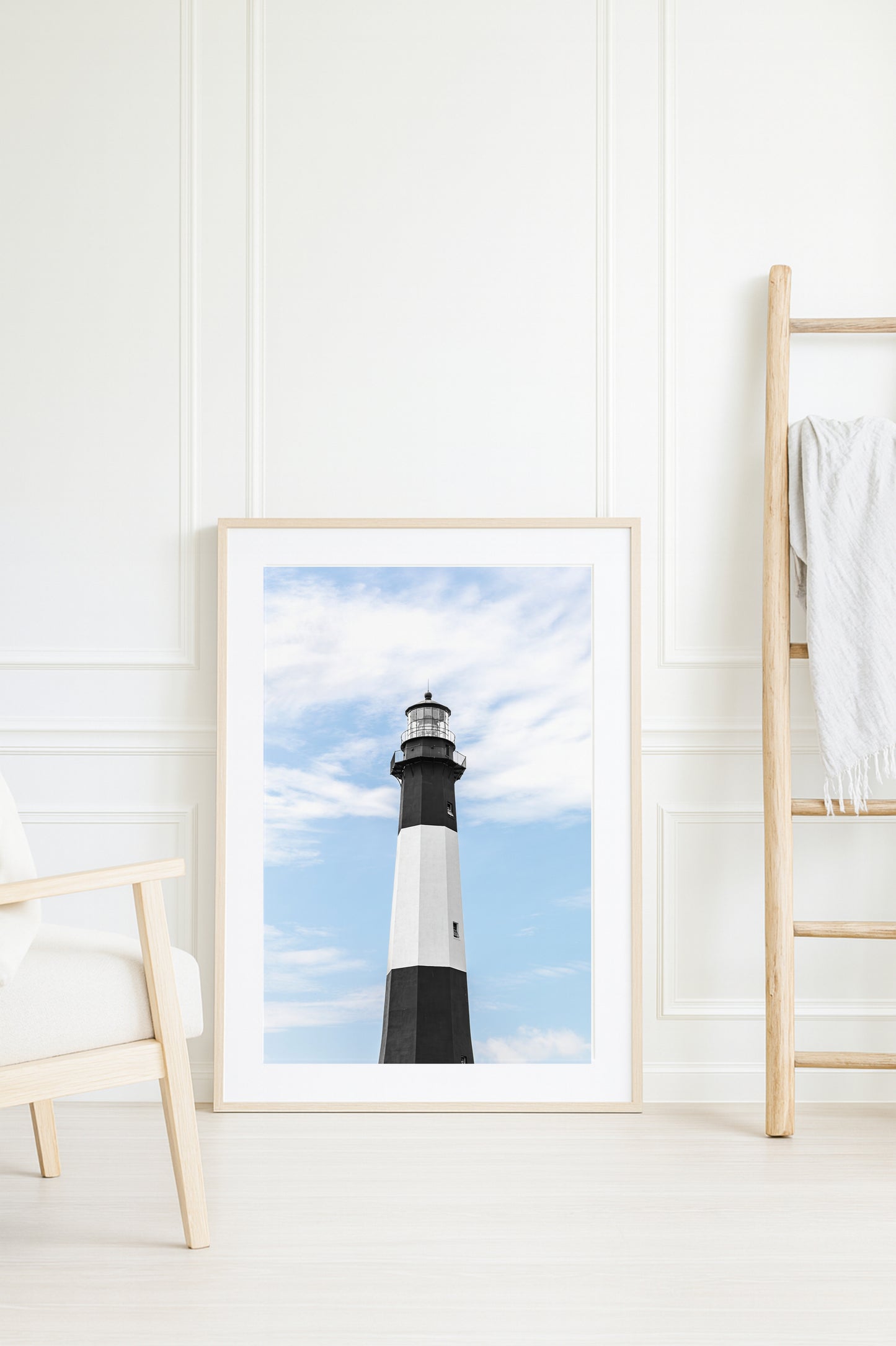 Fine art photograph of Tybee Island Lighthouse near Savannah, Georgia black and white striped tower against a soft blue sky, shot from below looking up