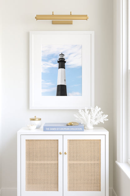 Fine art photograph of Tybee Island Lighthouse near Savannah, Georgia black and white striped tower against a soft blue sky, shot from below looking up