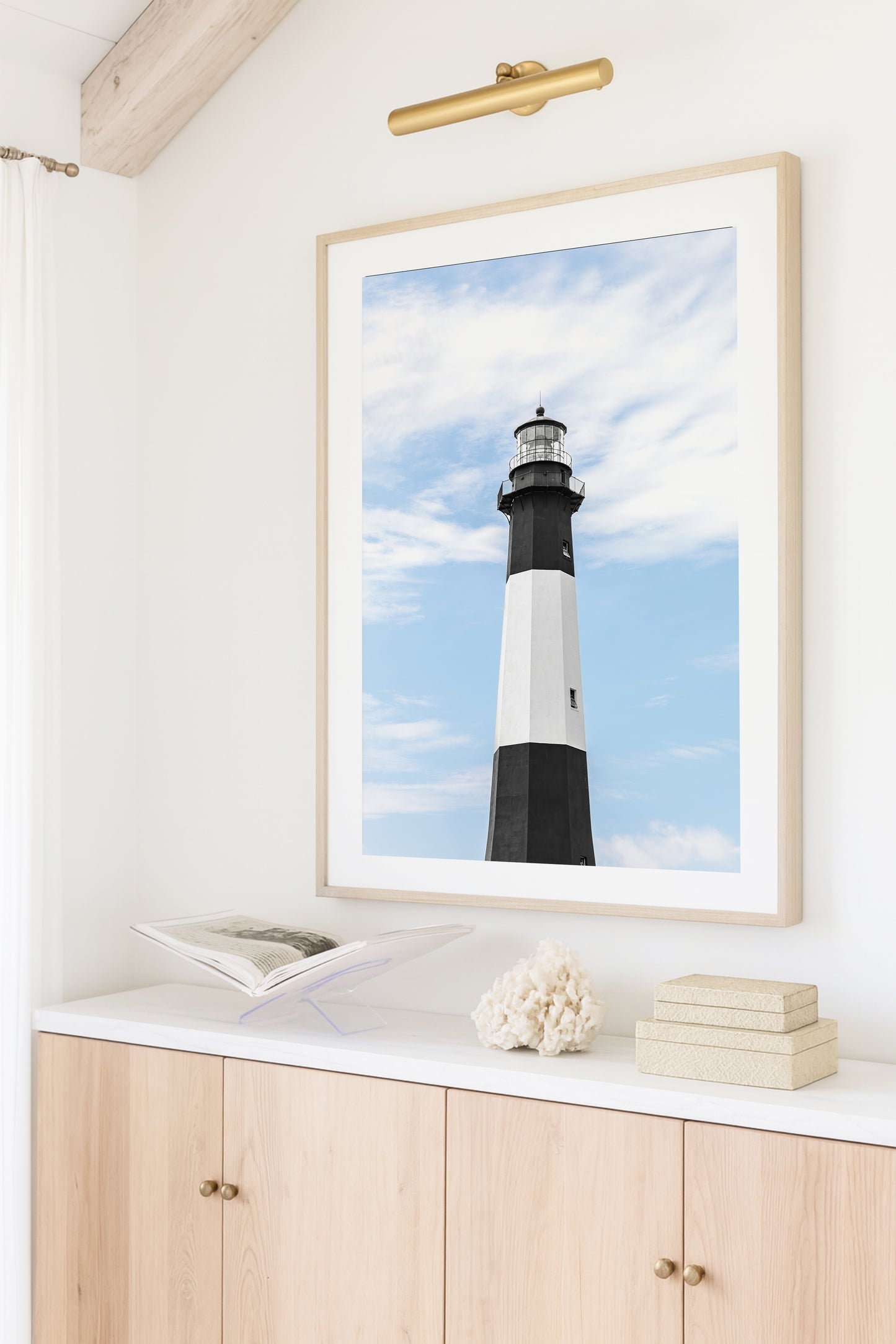 Fine art photograph of Tybee Island Lighthouse near Savannah, Georgia black and white striped tower against a soft blue sky, shot from below looking up