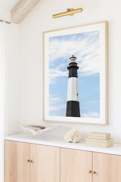 Fine art photograph of Tybee Island Lighthouse near Savannah, Georgia black and white striped tower against a soft blue sky, shot from below looking up