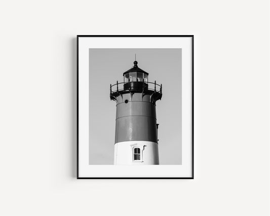 Black and white photograph of Nauset Lighthouse in Eastham, Massachusetts, featuring the iconic tower set against a pale sky. A minimalist coastal print ideal for Cape Cod–inspired decor and nautical wall art.