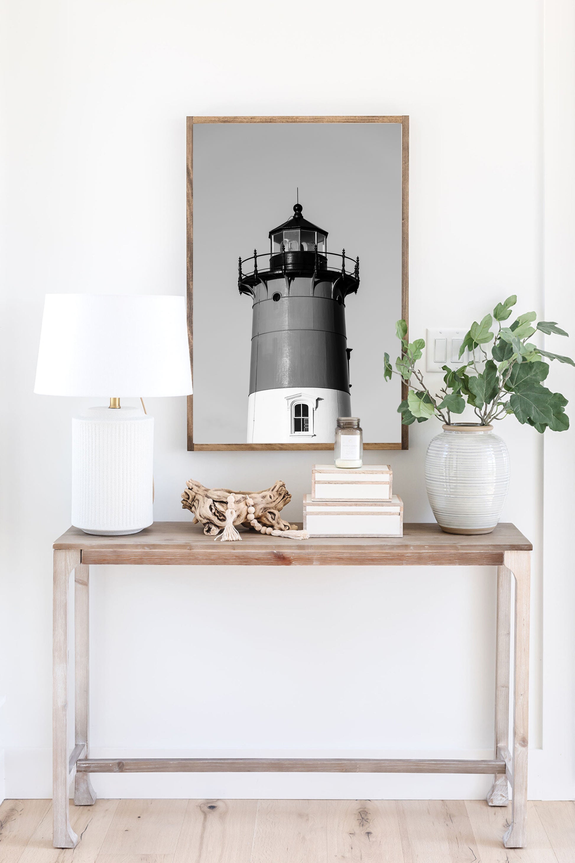 Black and white photograph of Nauset Lighthouse in Eastham, Massachusetts, featuring the iconic tower set against a pale sky. A minimalist coastal print ideal for Cape Cod–inspired decor and nautical wall art.