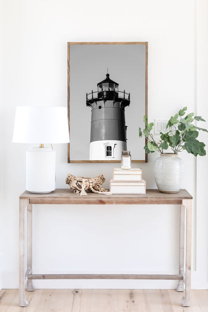 Black and white photograph of Nauset Lighthouse in Eastham, Massachusetts, featuring the iconic tower set against a pale sky. A minimalist coastal print ideal for Cape Cod–inspired decor and nautical wall art.