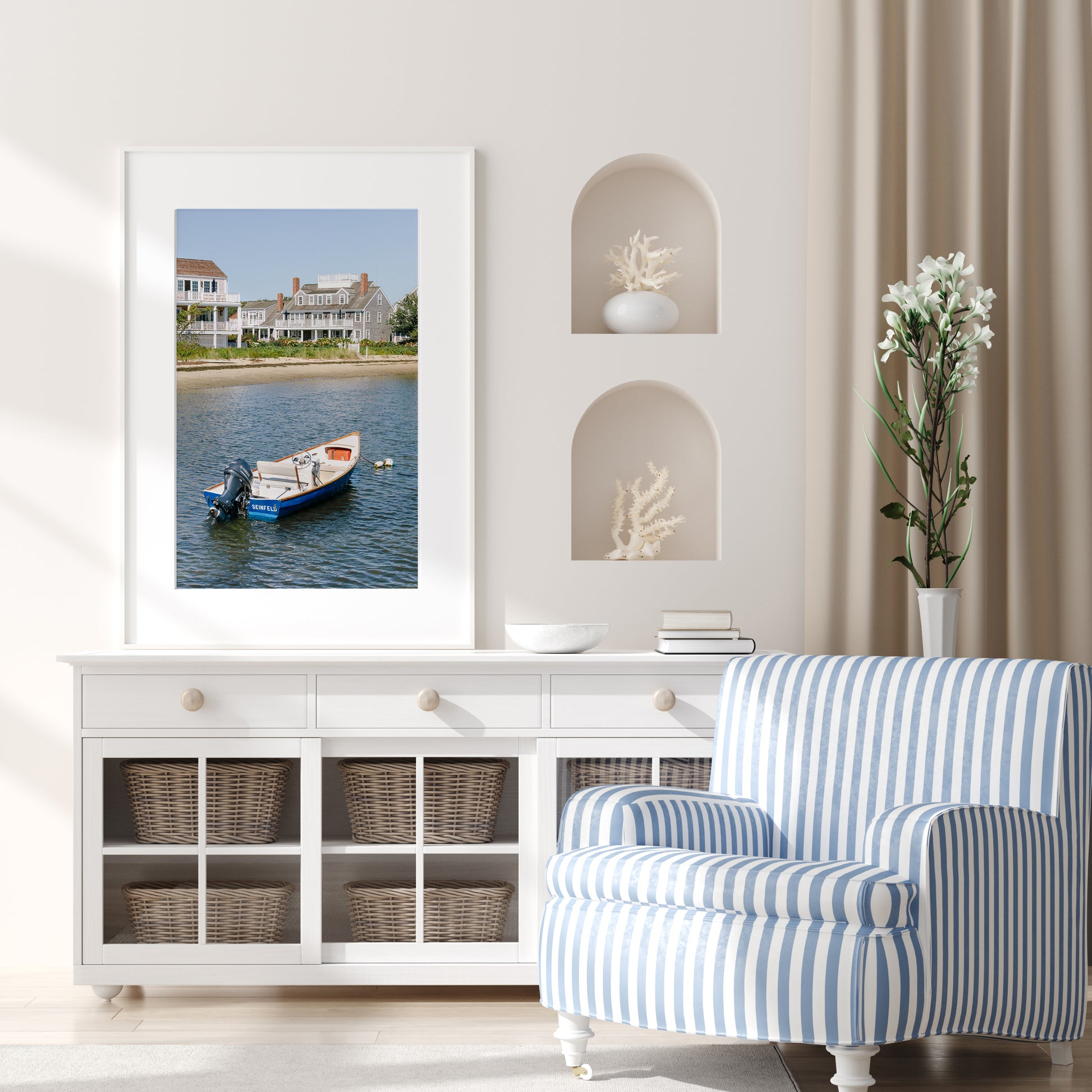 Vertical beach photography print of a small blue boat floating in Nantucket harbor, with Cape Cod-style houses and sandy shoreline in the background — perfect for nautical home decor and coastal wall art.