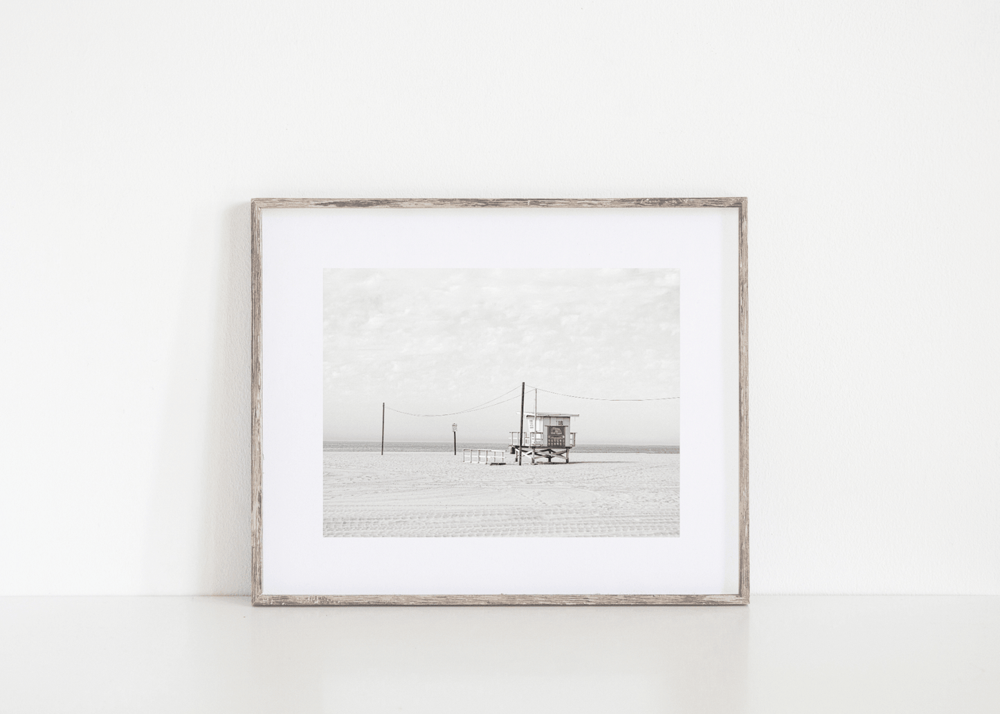 Framed black and white vintage beach photo with a lifeguard stand and ocean in the background. Beach print.  
